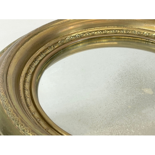 270 - A small vintage brass framed convex mirror. 33cm