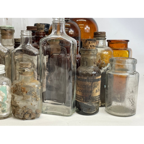 70 - A collection of vintage chemist bottles.