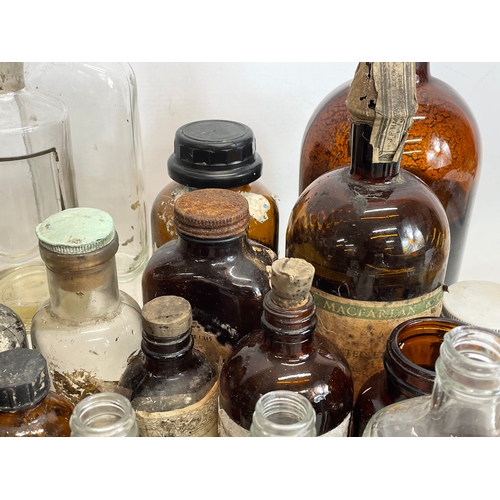 70 - A collection of vintage chemist bottles.