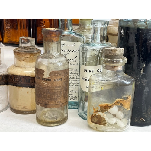 71 - A collection of early 20th century chemist bottles. Largest 23cm.