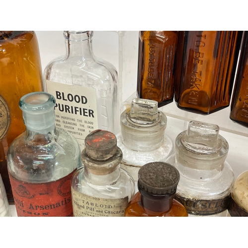 71 - A collection of early 20th century chemist bottles. Largest 23cm.