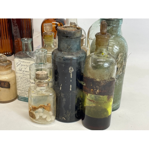 71 - A collection of early 20th century chemist bottles. Largest 23cm.