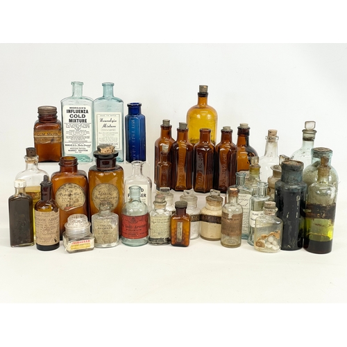 71 - A collection of early 20th century chemist bottles. Largest 23cm.