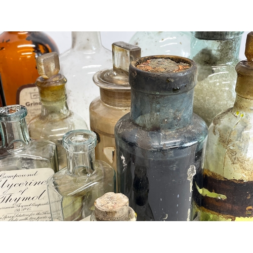 71 - A collection of early 20th century chemist bottles. Largest 23cm.