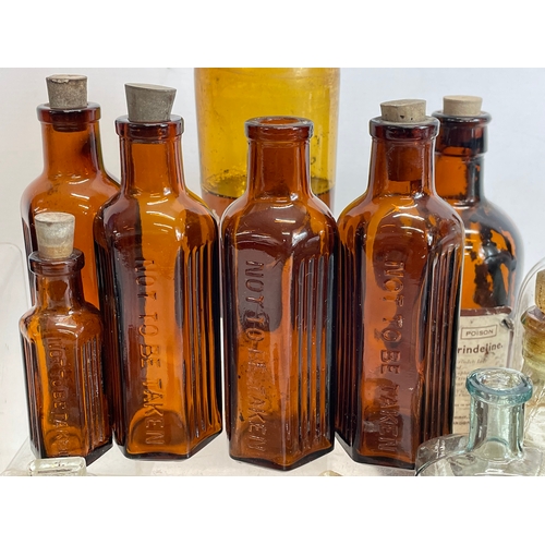 71 - A collection of early 20th century chemist bottles. Largest 23cm.