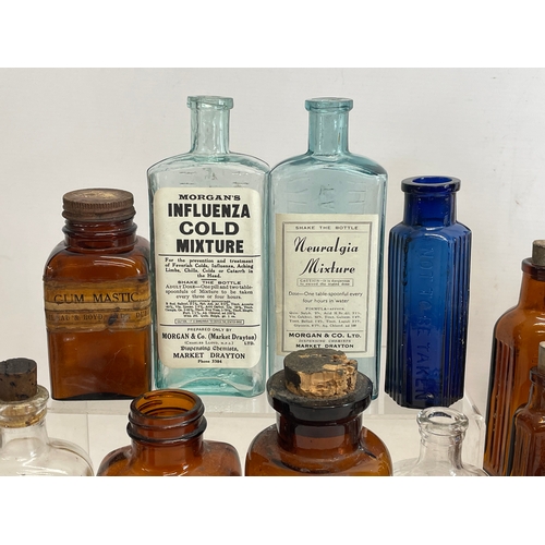 71 - A collection of early 20th century chemist bottles. Largest 23cm.