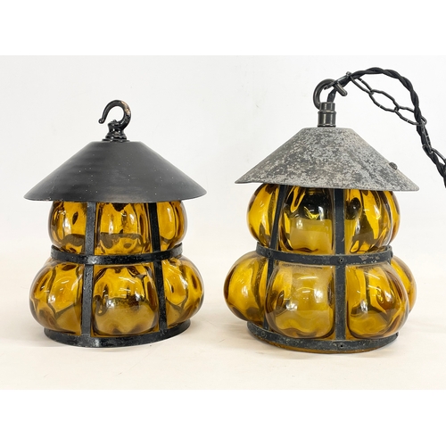 131 - A pair of vintage wrought iron Amber Bubble Glass light fittings. 17x22cm