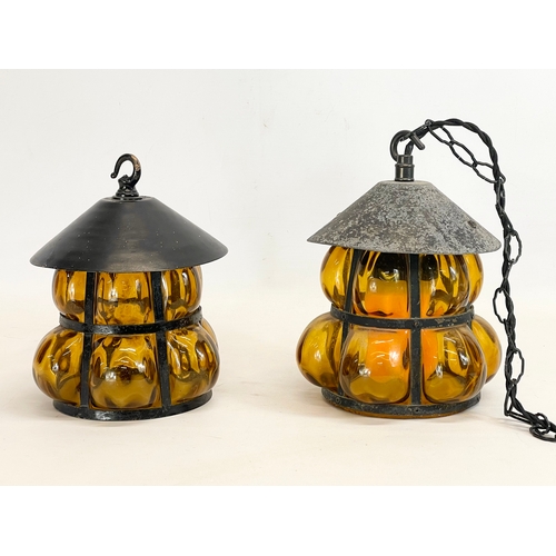 131 - A pair of vintage wrought iron Amber Bubble Glass light fittings. 17x22cm