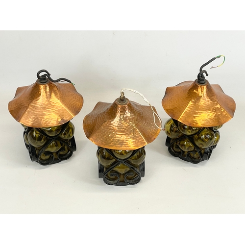 132 - A set of 3 vintage wrought iron bound Amber Bubble Glass light fittings. 19x26cm