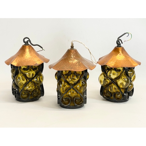 132 - A set of 3 vintage wrought iron bound Amber Bubble Glass light fittings. 19x26cm