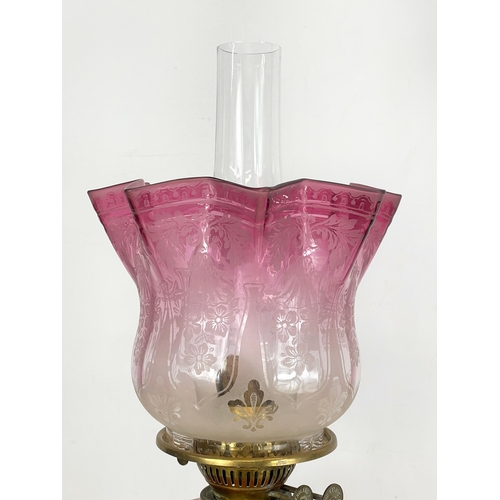 21 - A large Victorian Ruby Glass and brass double burner oil lamp. 72cm