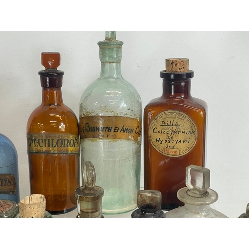 75 - A collection of early 20th century chemist bottles. Largest 32cm. 24cm