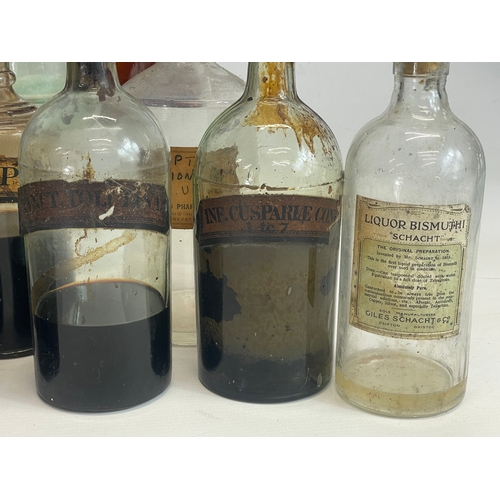 75 - A collection of early 20th century chemist bottles. Largest 32cm. 24cm