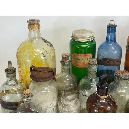 75 - A collection of early 20th century chemist bottles. Largest 32cm. 24cm