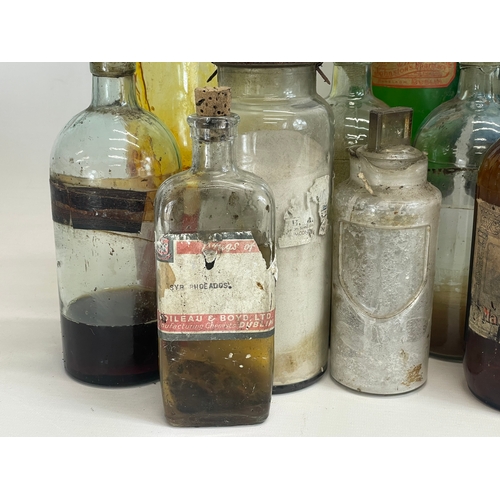 75 - A collection of early 20th century chemist bottles. Largest 32cm. 24cm