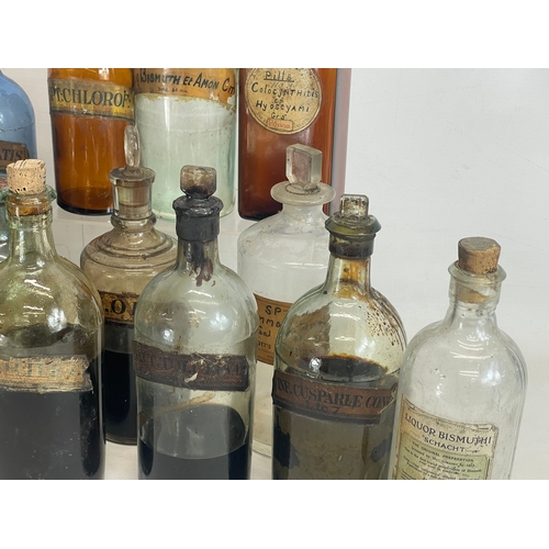 75 - A collection of early 20th century chemist bottles. Largest 32cm. 24cm