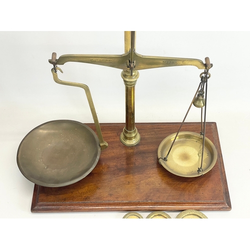 76 - A set of Edwardian W&T Avery LTD Class B brass balance scales with Avery weights. 51x28x58cm