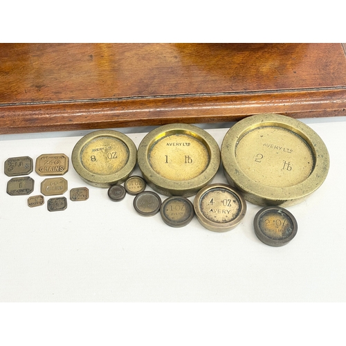 76 - A set of Edwardian W&T Avery LTD Class B brass balance scales with Avery weights. 51x28x58cm