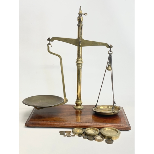 76 - A set of Edwardian W&T Avery LTD Class B brass balance scales with Avery weights. 51x28x58cm