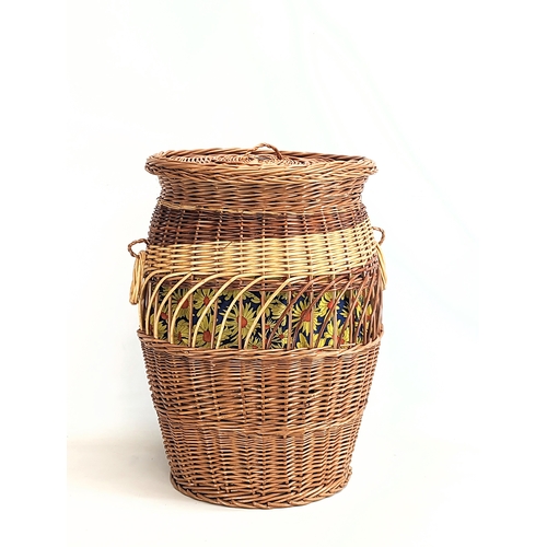 325 - A large good quality wicker linen basket with handles and lid. 61cm