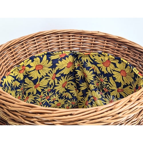 325 - A large good quality wicker linen basket with handles and lid. 61cm