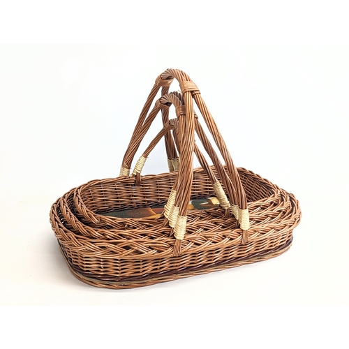 324 - A set of 3 god quality wicker picnic baskets. Largest measures. 54x38cm