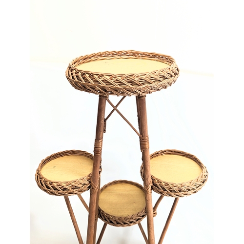 323 - A large good quality wicker plant stand. 114cm