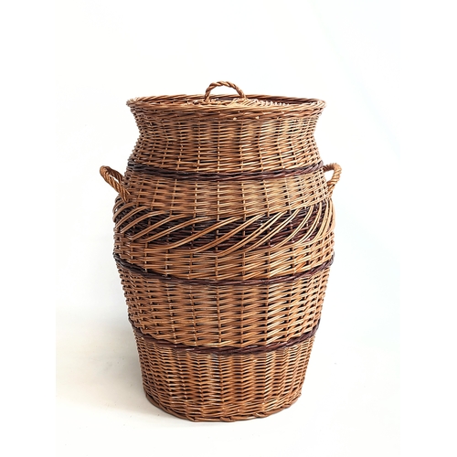 322 - A large good quality wicker linen hamper with handles and lid. 59.5cm