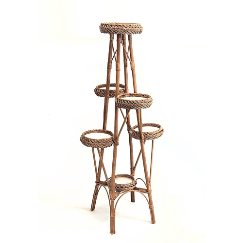 321 - A tall wicker plant stand. 113cm