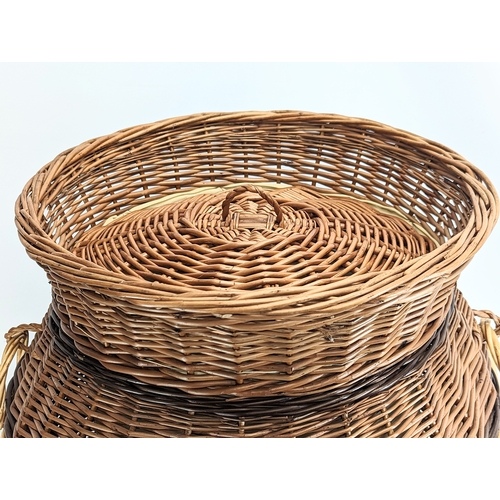 307 - A large good quality wicker linen hamper with handles and lid. 65.5cm