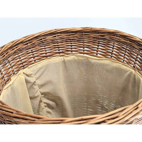 307 - A large good quality wicker linen hamper with handles and lid. 65.5cm