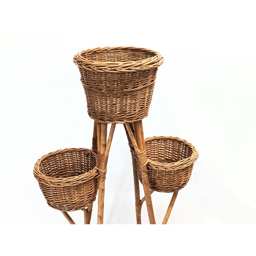 302 - A tall good quality wicker plant stand. 103.5cm