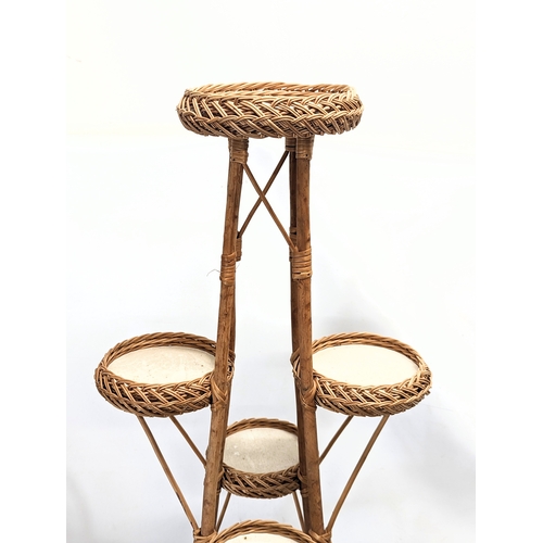 301 - A tall good quality wicker plant stand. 113cm