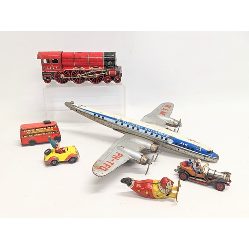 218 - A collection of vintage tin toys with a Corgi Chitty Chitty Bang Bang model car.