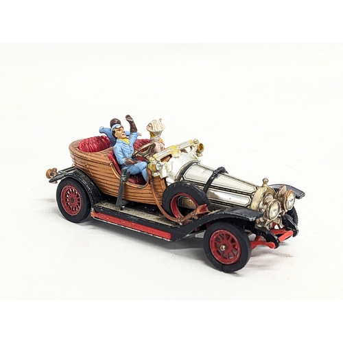 218 - A collection of vintage tin toys with a Corgi Chitty Chitty Bang Bang model car.