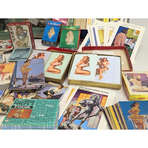 225 - A collection of vintage playing cards, postcards in album, vintage Pinup Girl cards, novelty postcar... 