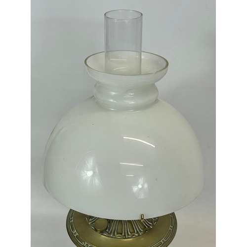 30 - An early 20th century Aladdin Model 9 brass oil lamp with glass shade. 54cm