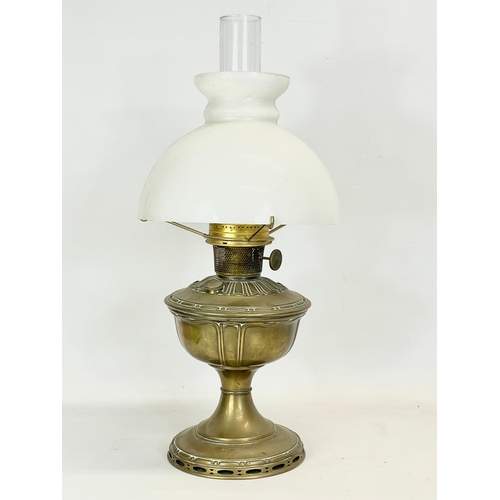 30 - An early 20th century Aladdin Model 9 brass oil lamp with glass shade. 54cm