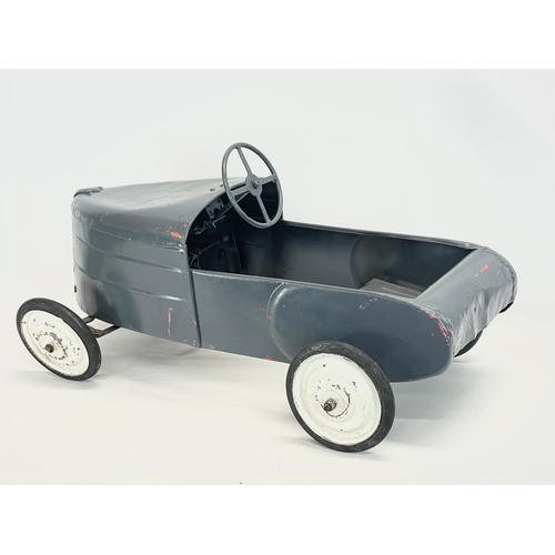 228 - A vintage metal child’s peddle car. 90cm