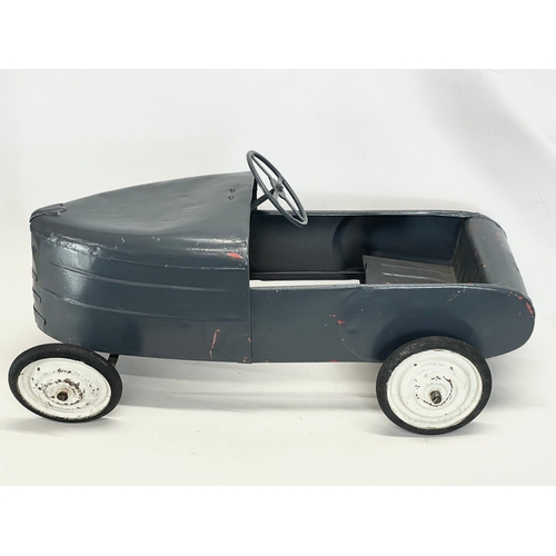 228 - A vintage metal child’s peddle car. 90cm