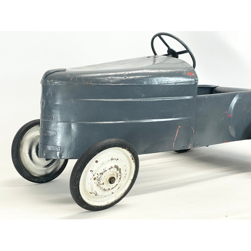 228 - A vintage metal child’s peddle car. 90cm