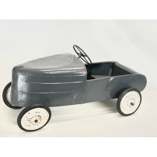 228 - A vintage metal child’s peddle car. 90cm