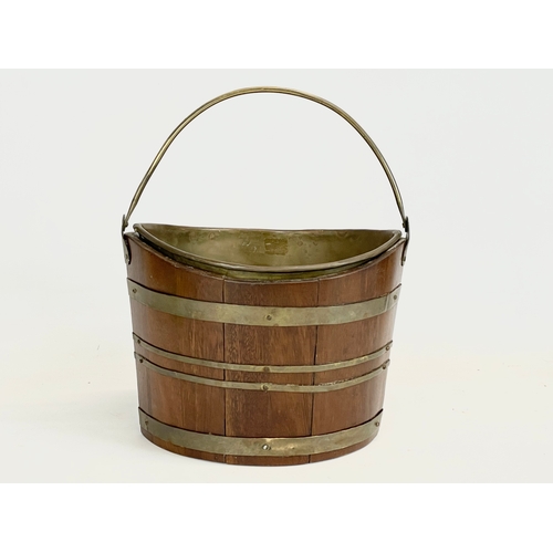 35 - A small Edwardian oak brass bound ice bucket. 26x18x20cm not including handle.