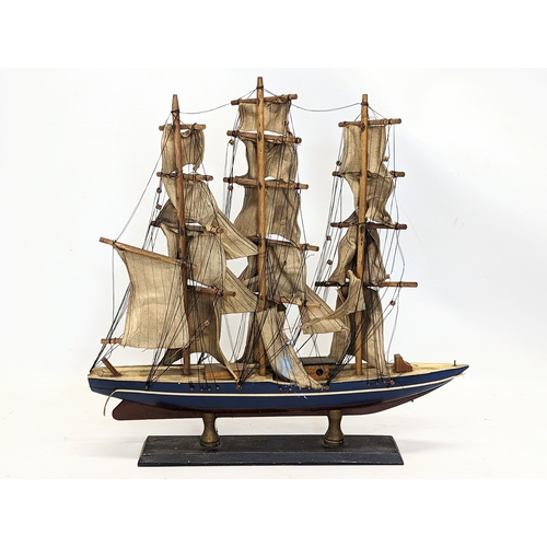 138 - 2 early 20th century wooden model ships. Largest measures 45x44.5cm