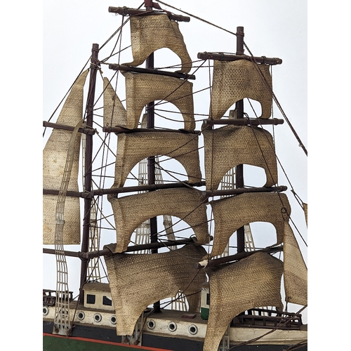 138 - 2 early 20th century wooden model ships. Largest measures 45x44.5cm