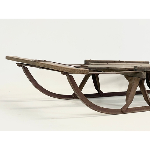 85 - An early 20th century wood and metal child’s sleigh. 82cm