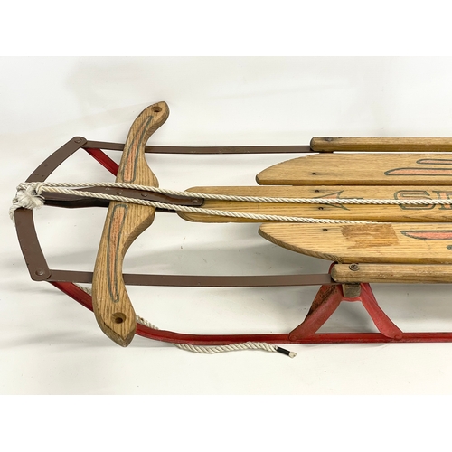 86 - A vintage Speedway wood and metal sled. 143cm