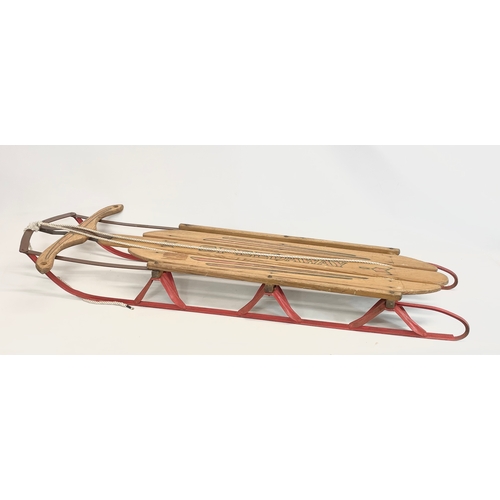 86 - A vintage Speedway wood and metal sled. 143cm