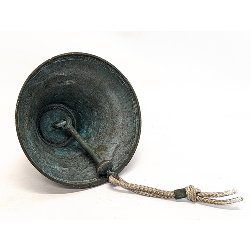 145 - An early 20th century brass bell with clanger. 17.5x13.5cm