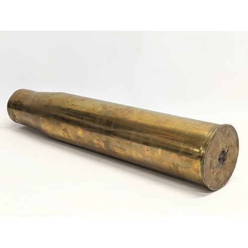 296 - A large brass canon shell. 69.5cm